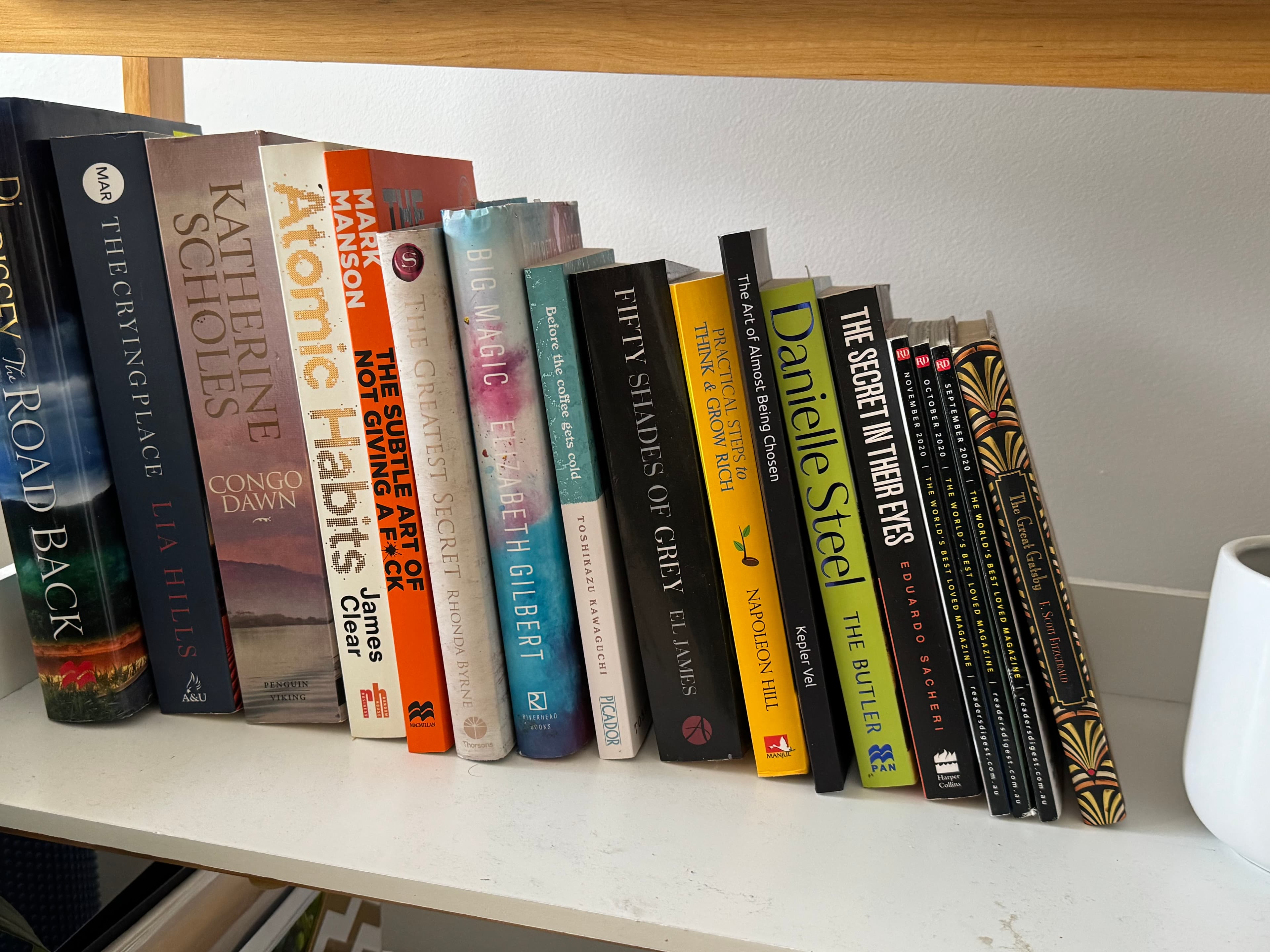 The book on a shelf alongside Atomic Habits, Big Magic and other bestsellers